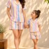 Mother and daughter in matching pastel candy-stripe night suits